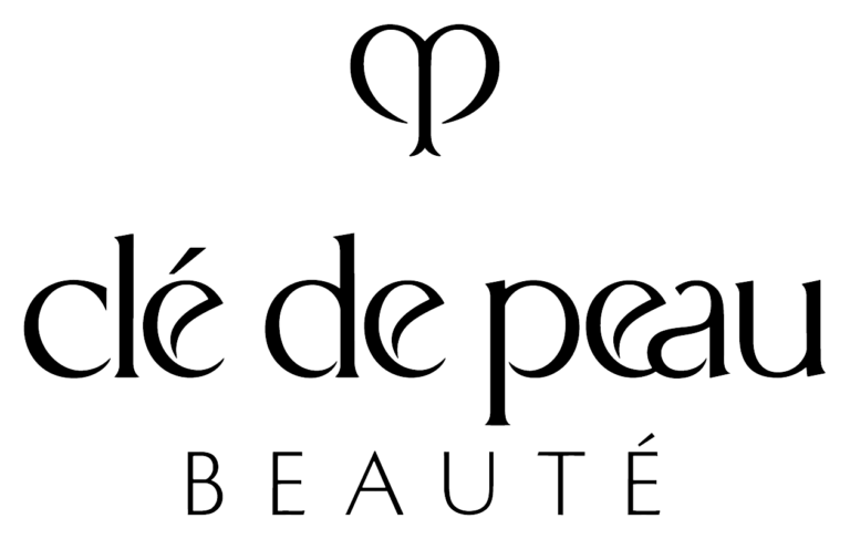 Clé de Peau Beauté logo featuring elegant black serif text and a stylized heart-shaped emblem above the brand name on a light background.